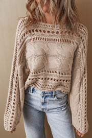 Dust Storm acrylic cable knit sweater with cutout details and open knit sleeves.