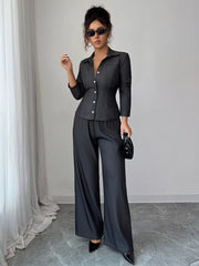 Gray button-up shirt and wide-leg pants set with button details and elastic waist.