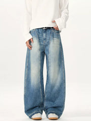 Relaxed fit baggy blue washed cotton jeans with a faded look.