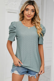 Perforated puff sleeve top in light green with a diamond pattern and round neckline.