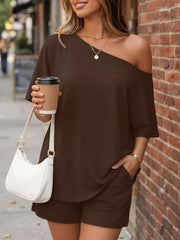Dark brown asymmetrical one-shoulder top with pockets and matching shorts set.