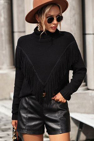 Black turtleneck sweater with fringe detail and chevron pattern, long sleeves.