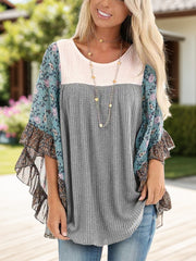 Textured panel blouse in gray with floral flutter sleeves and ruffled trim.