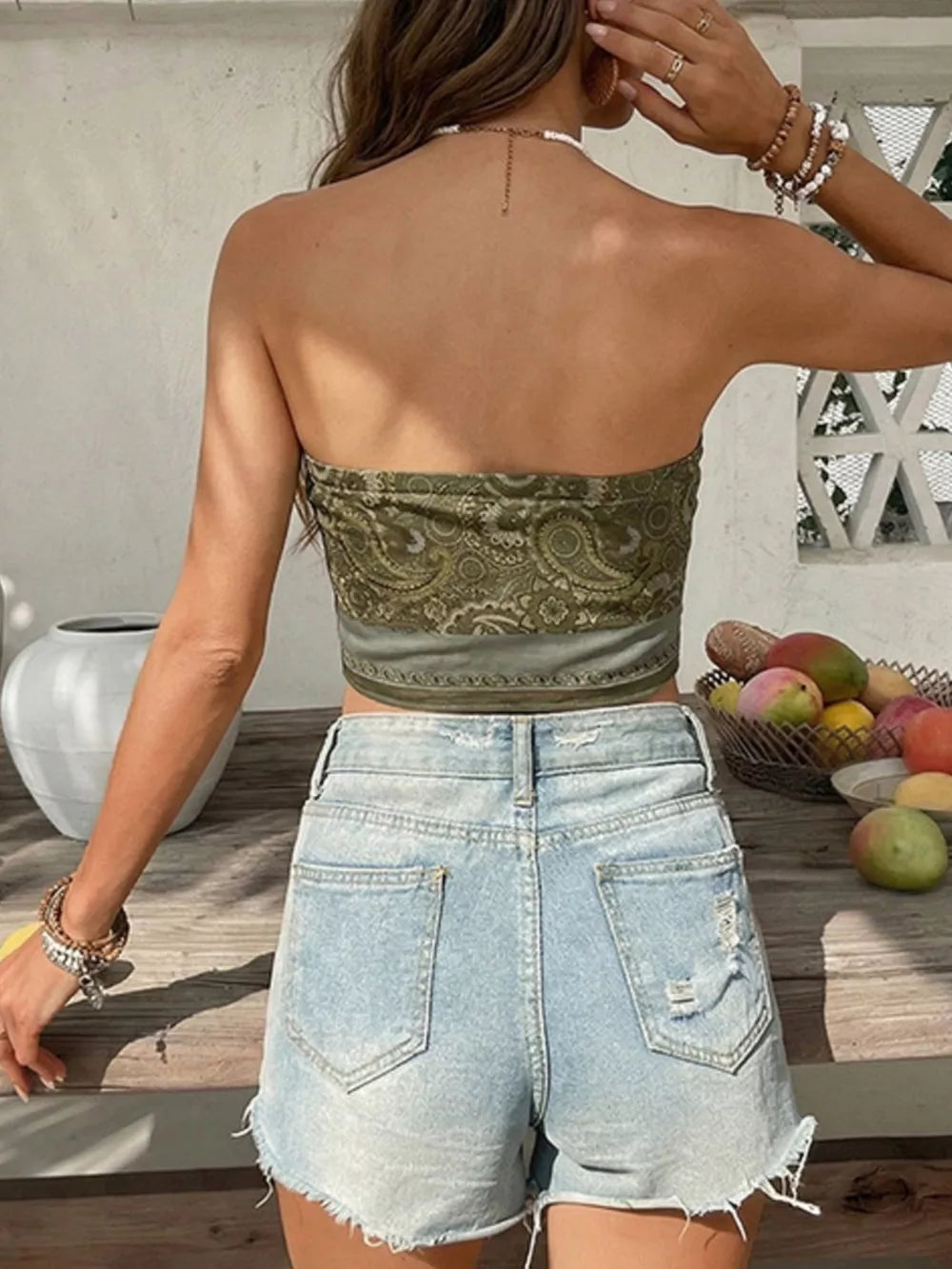 Vibrant paisley print bandeau top in olive green, cropped length, strapless.