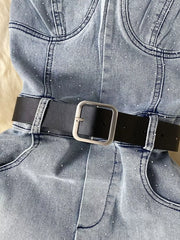 Blue denim romper with allover rhinestones and black belt with silver buckle.