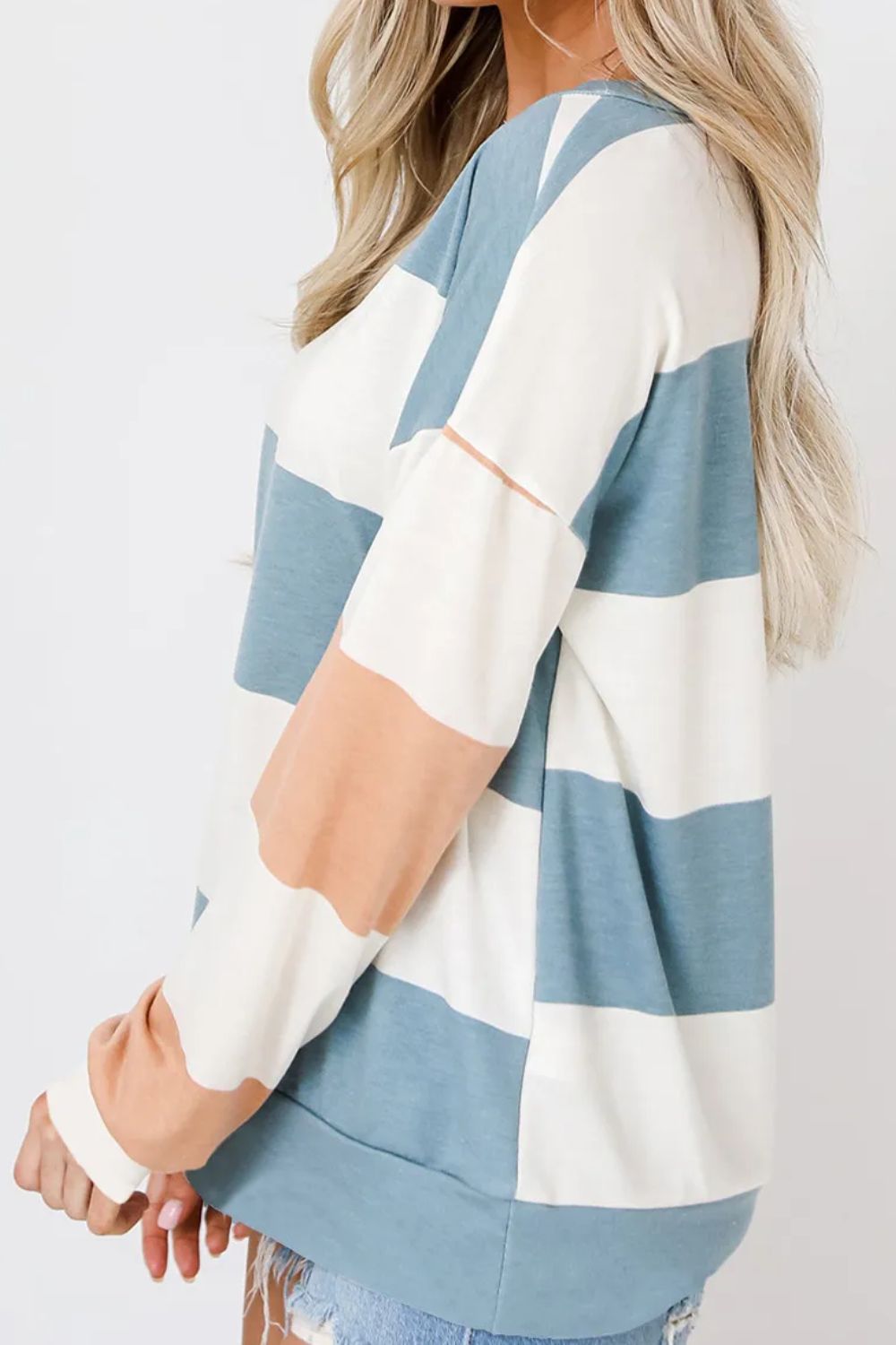Striped sweatshirt with block sleeves in blue, white, and blush pink.