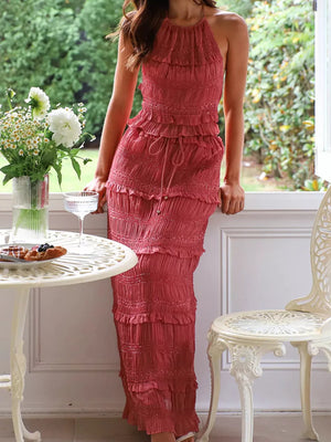 Brick-red halter neck smocked tiered maxi dress with ruffle trim and drawstring waist.