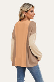 Colorblock waffle knit pullover sweater with long sleeves in tan, rust, and beige.
