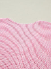 Pink acrylic sweater vest with V-neck detail and ribbed knit texture.
