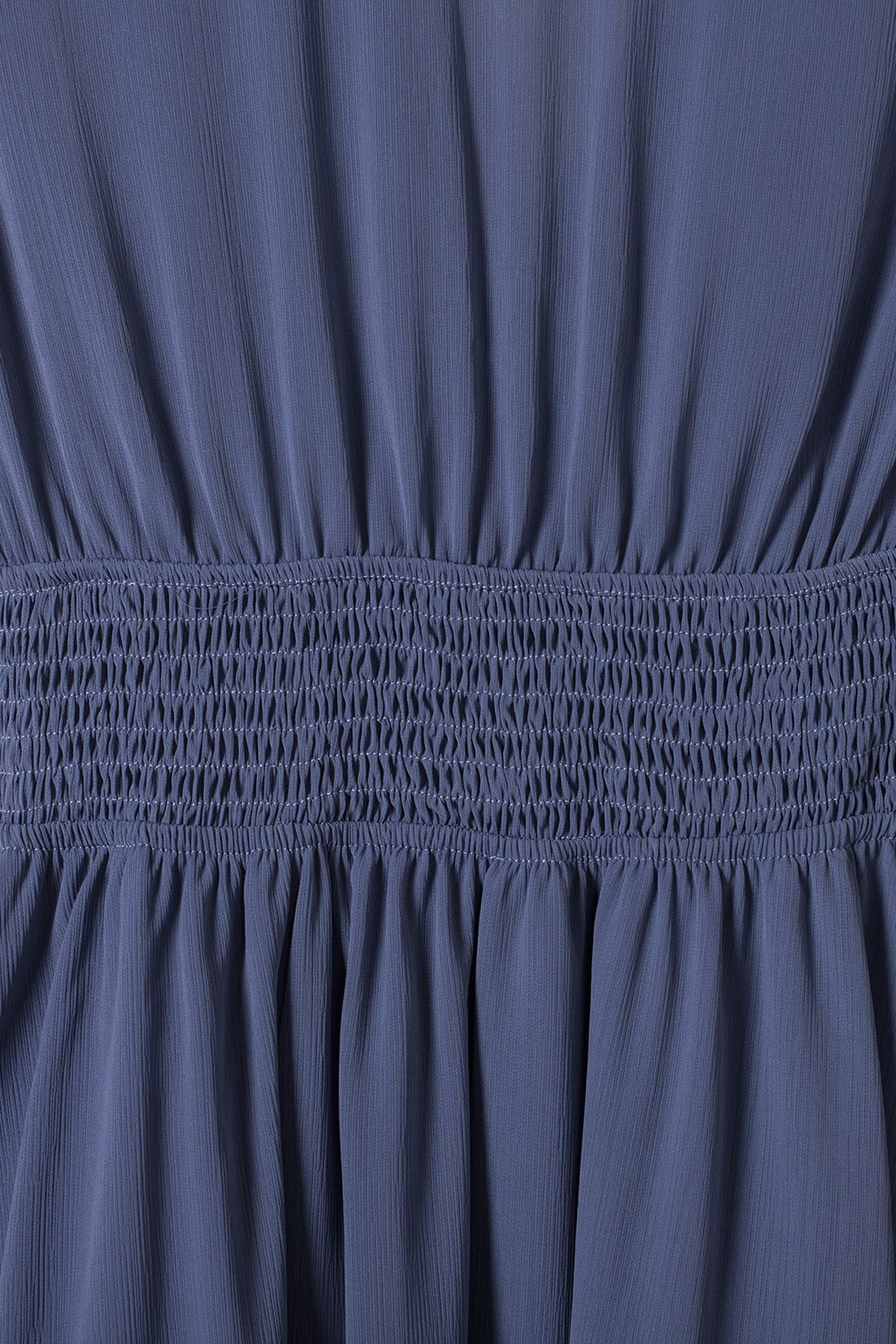 Dusty blue dress with smocked waist and textured fabric detail