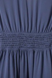 Dusty blue dress with smocked waist and textured fabric detail