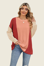 Colorblock waffle knit pullover with crew neck and long sleeves in rust, peach, and tan.