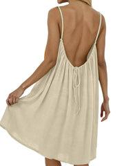 Beige backless spaghetti strap dress with tie detail at the back.