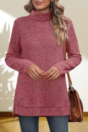 Ribbed knit turtleneck tunic top in Cerise with long sleeves and side slits.