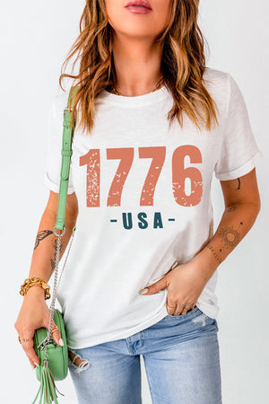 White graphic tee with distressed 1776 USA print and short sleeves.