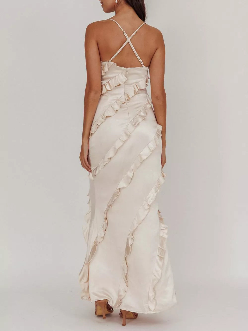 Beige spaghetti strap maxi dress with diagonal ruffles and criss-cross back straps.