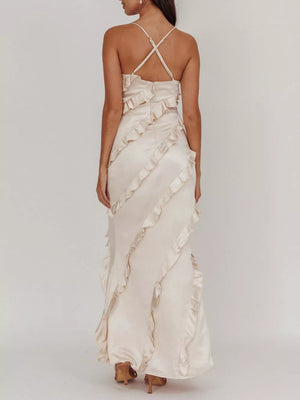 Beige spaghetti strap maxi dress with diagonal ruffles and criss-cross back straps.
