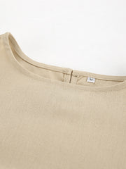Tan cotton crew neck sleeveless crop top with back closure detail.