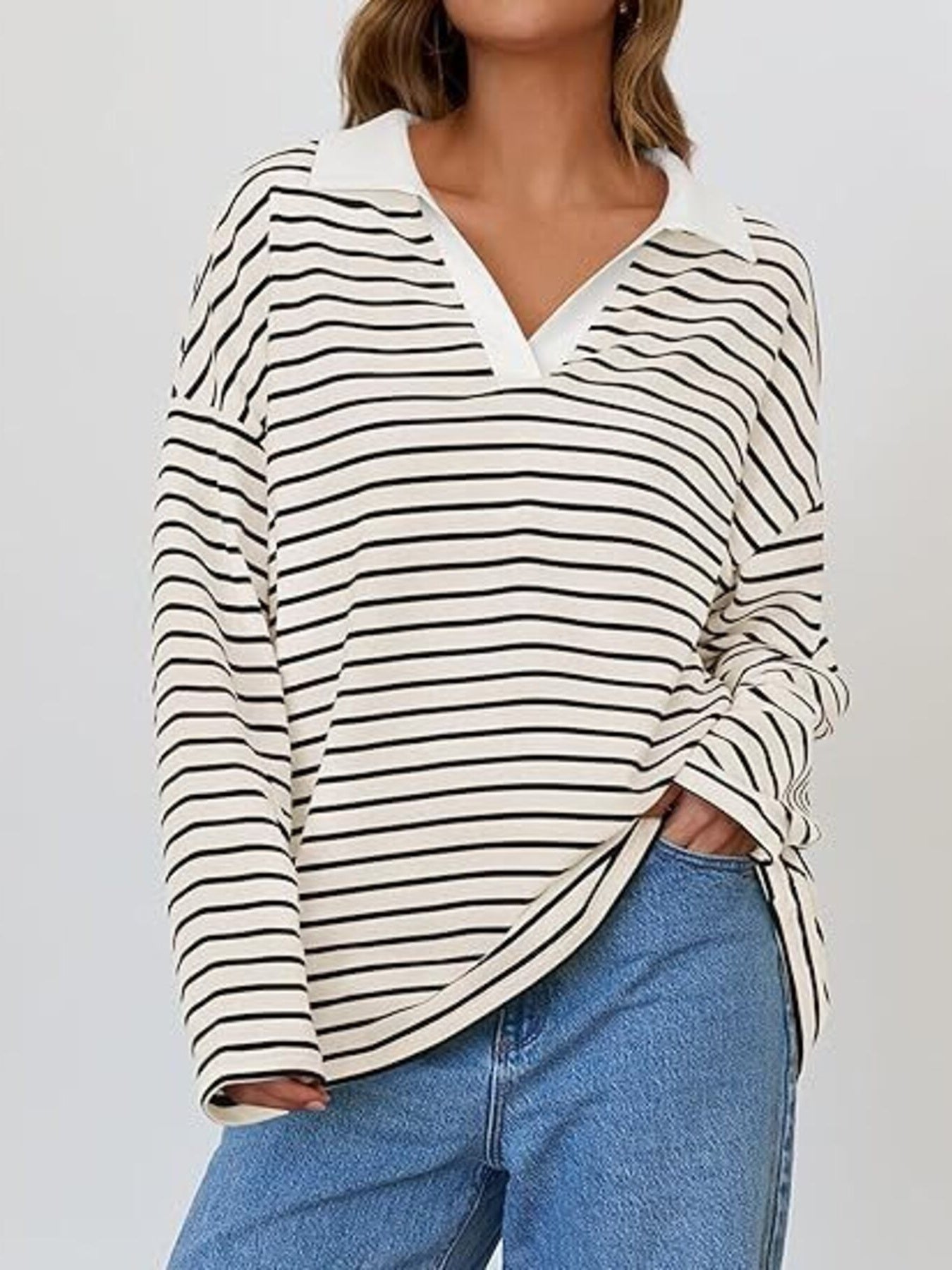 Oversized striped long-sleeve sweatshirt in cream and black with a white collar and v-neck.