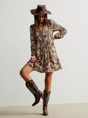 Brown floral print dress with notched neckline and long sleeves, detailed with lace trim.