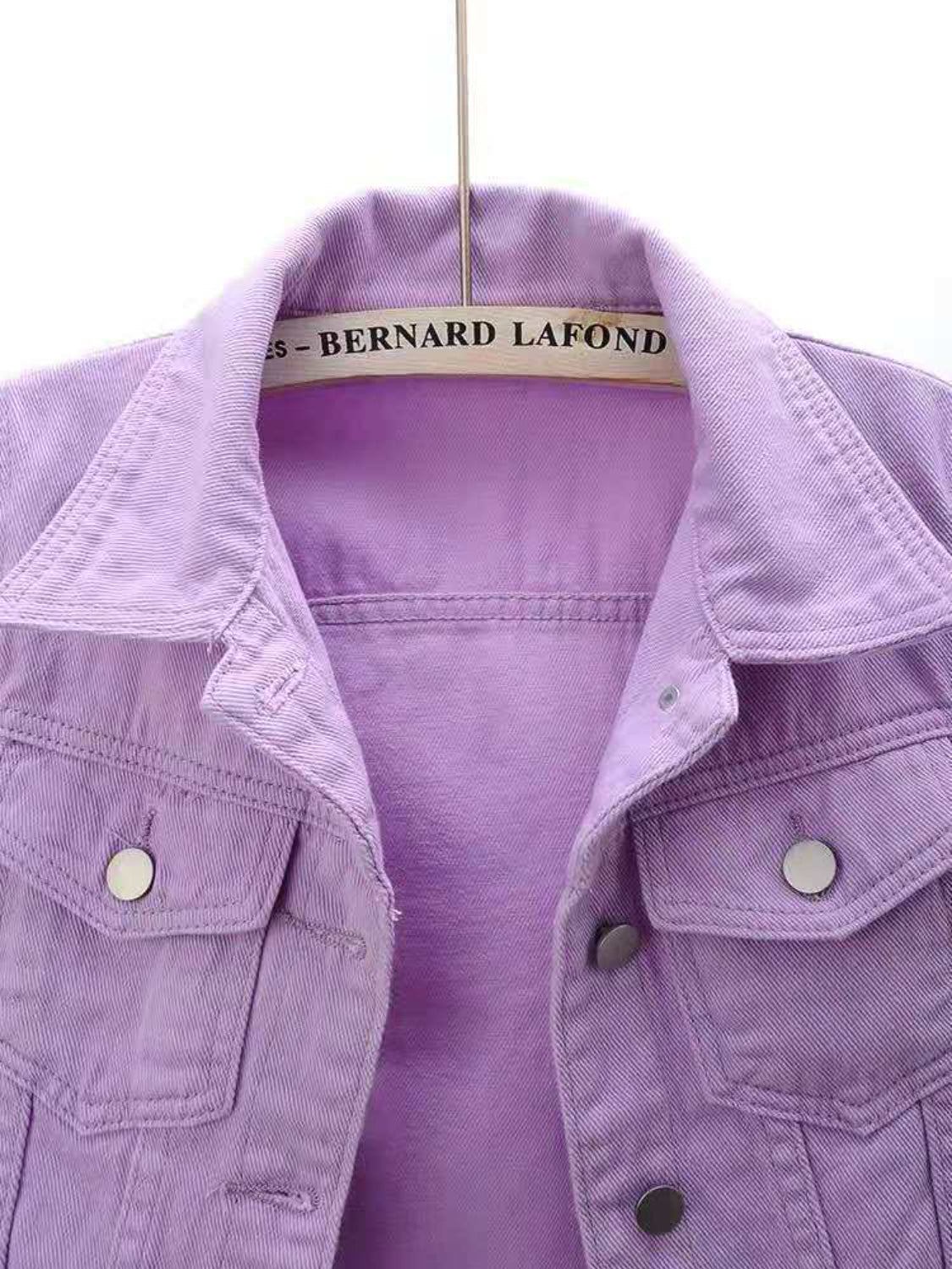 Lavender denim trucker jacket with button pockets and collar detail.
