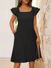 Black a-line dress with ruffled cap sleeves and square neckline.