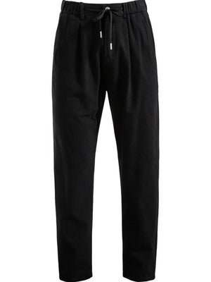 Black pleated linen drawstring trousers with a relaxed fit.