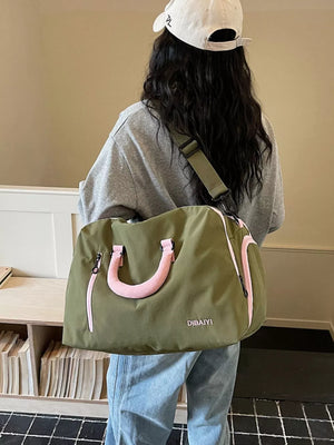 Chic olive travel bag with pink accents and adjustable strap