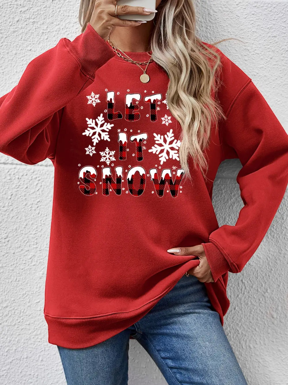 Red crewneck sweatshirt with "Let It Snow" graphic and snowflakes.