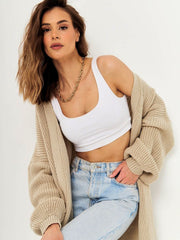 Oversized tan ribbed knit maxi cardigan with dropped shoulders and wide sleeves.