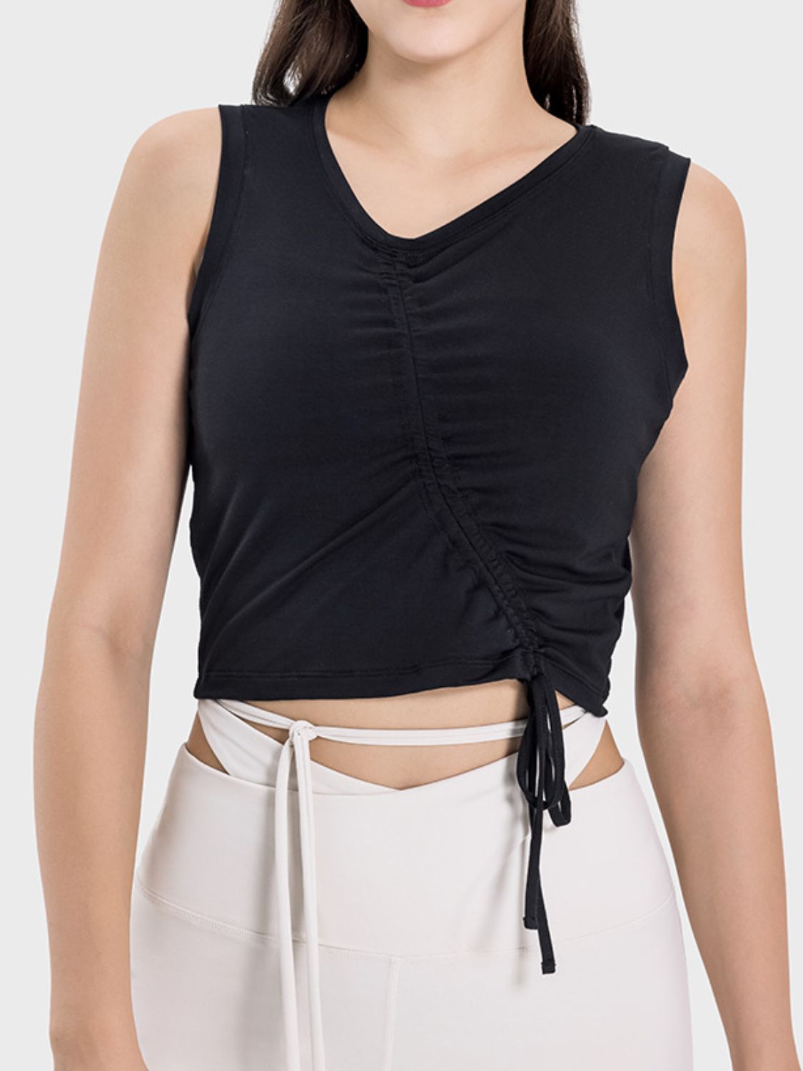 Black asymmetric ruched crop tank top with V-neck and adjustable drawstring detail.