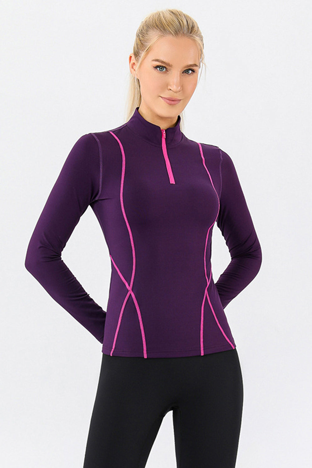 Violet athleisure zip-neck top with contrast pink seam details and long sleeves.