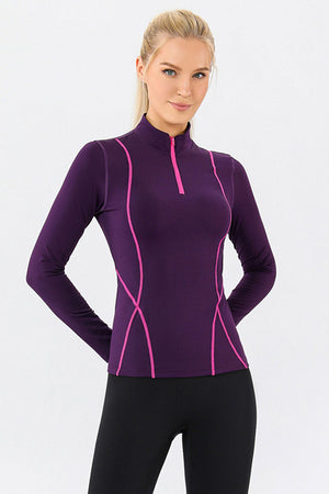 Violet athleisure zip-neck top with contrast pink seam details and long sleeves.