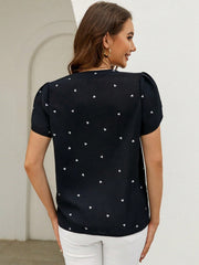 Black heart print puff sleeve blouse with a V-neckline.