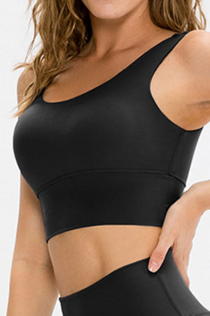 Seamless black scoop neck crop top with a wide band and racerback detail.