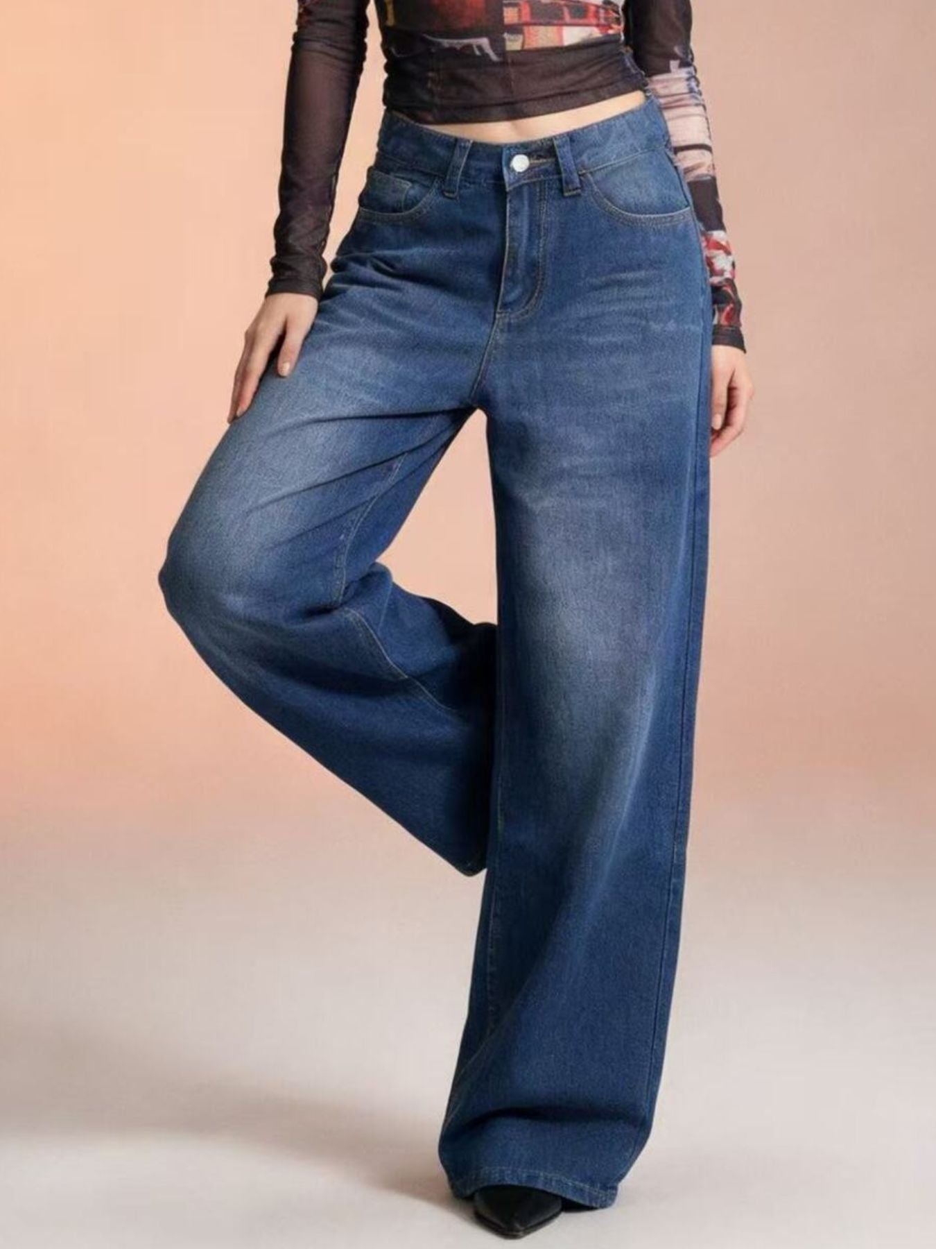 Cutout high-waisted wide-leg jeans in blue denim with button closure and pockets.