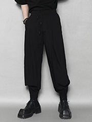 Black sweatpants with drawstring waist and ankle cuffs.