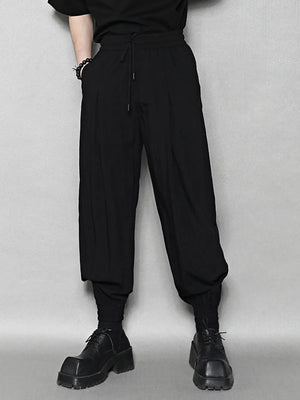 Black sweatpants with drawstring waist and ankle cuffs.