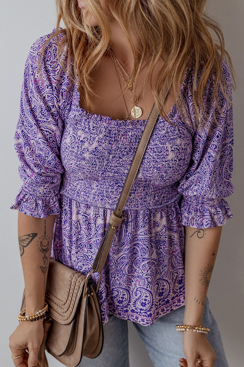 Paisley smocked bodice blouse in lavender with square neckline and ruffled sleeves.