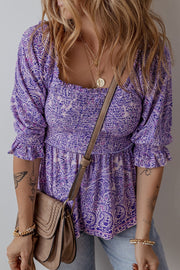 Paisley smocked bodice blouse in lavender with square neckline and ruffled sleeves.