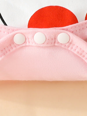 Pink baby bodysuit with bunny ears and red accents, featuring snap closures.