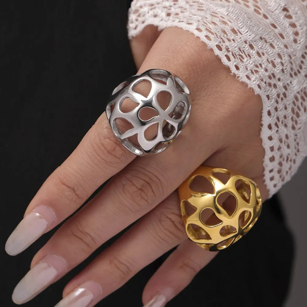 Openwork orb rings in gold and silver, showcasing a contemporary, hollow design.