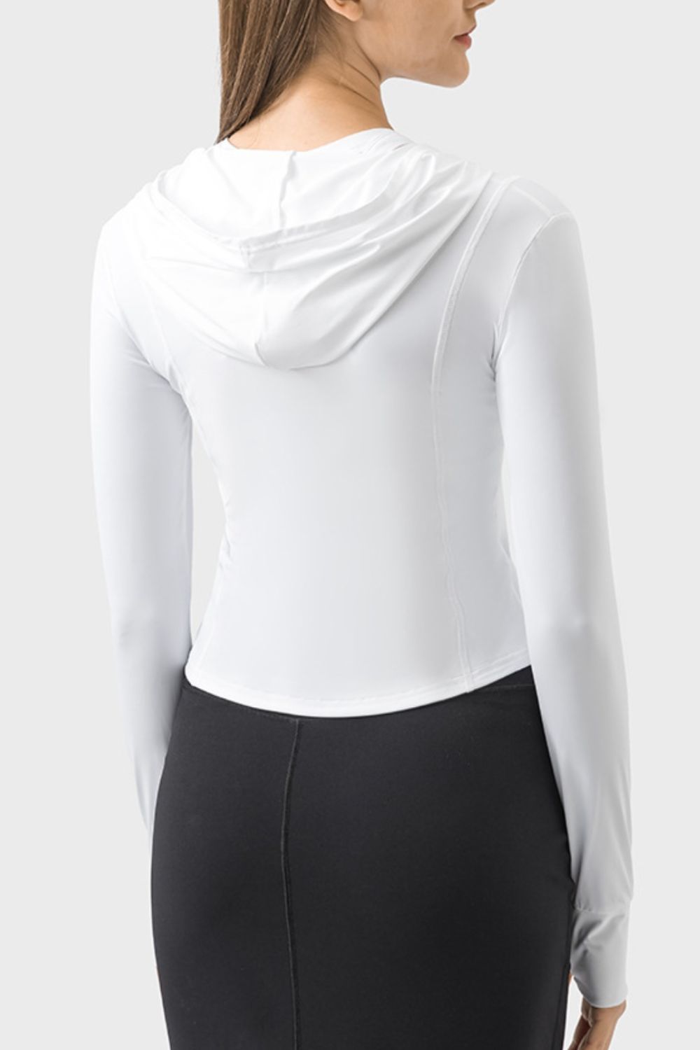 White active hoodie with thumbholes and a fitted silhouette.
