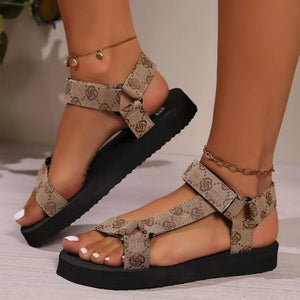 Bow-Tie Platform Sandals in Tan with all-over logo pattern and ankle straps.