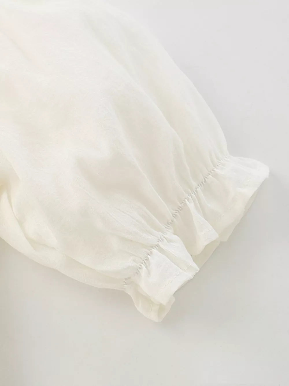 Cream cotton blend toddler dress sleeve detail with ruffled cuff
