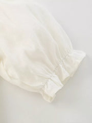 Cream cotton blend toddler dress sleeve detail with ruffled cuff