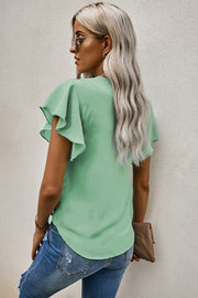 Button-down blouse in Gum Leaf green with ruffled short sleeves and a tie-front detail.