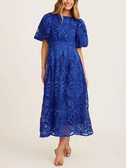 Blue lace midi dress with puff sleeves and intricate allover pattern.