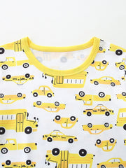 Toddler pajama set with yellow cartoon car print and bright yellow trim.