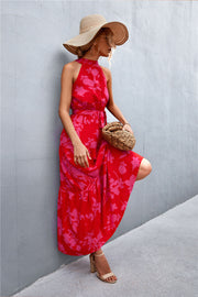 Red floral print halter neck maxi dress with tiered skirt.
